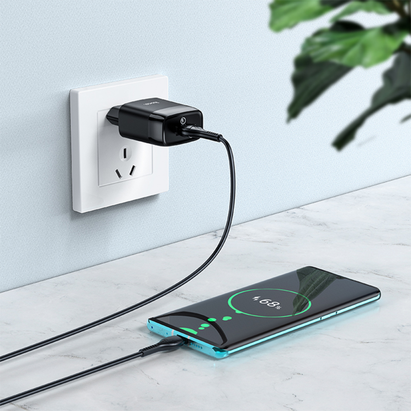 3.0 usb charger is plugged into the wall socket with braided cable connected to it which is charging the phone