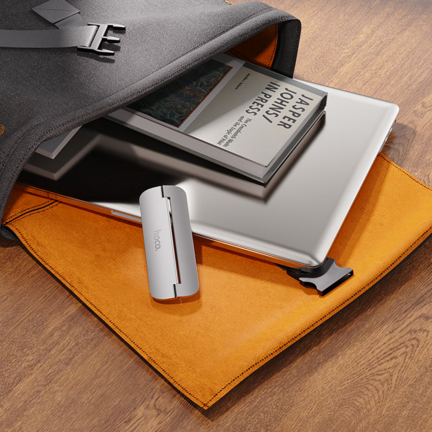 An image showing Metal Foldable Laptop Stand (PH40) is out of laptop bag with laptop and books