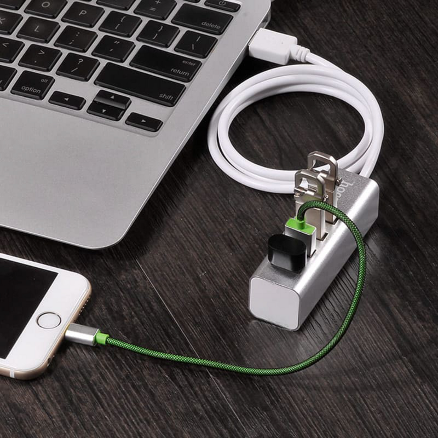 A photo showing 4 port usb hub being used, connected to the laptop and charging a phone