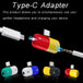 Close view of Type-c adapter with type-C and aux connectors next to it. Below are different colors of type-C adapters