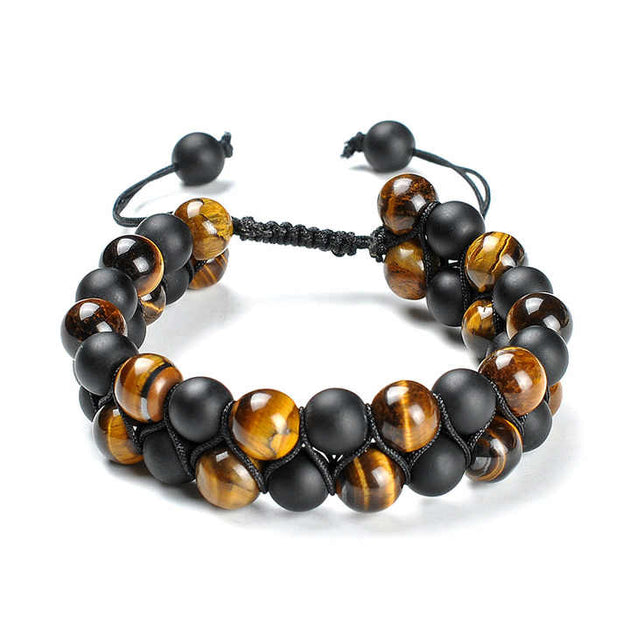 Braided rope bracelet with black and brown beads. The bracelet is lying flat on a white background. 